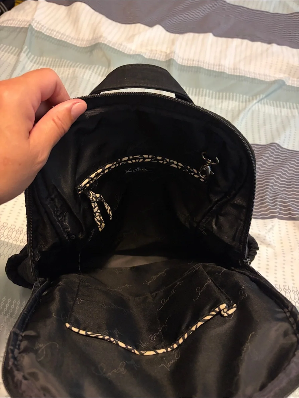 Vera Bradley Black Quilted Backpack with Front Buckle Pockets.